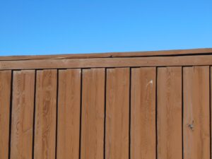 a wooden fence with a blue sky in the background 1