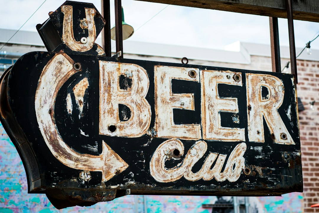 an old neon sign advertising a beer company